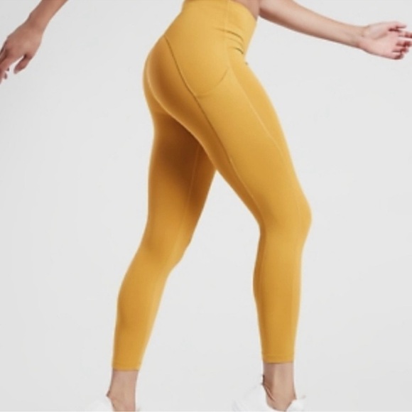 Athleta Pants - BAG361. NWT Athleta Ultimate Stash 7/8 Long side
Pockets Golden Mustard Leggings
